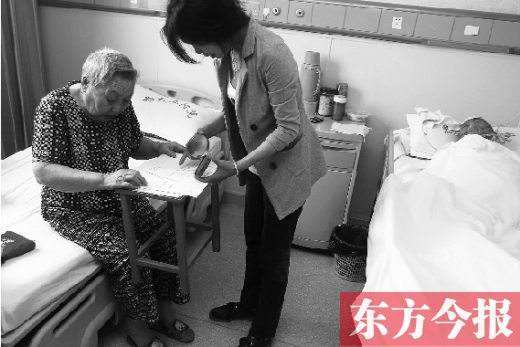 昨日，鄭大五附院二號(hào)樓住院部，馬老太寫下委托書，并簽字摁指印委托女兒代理為昏迷老伴解鎖取錢