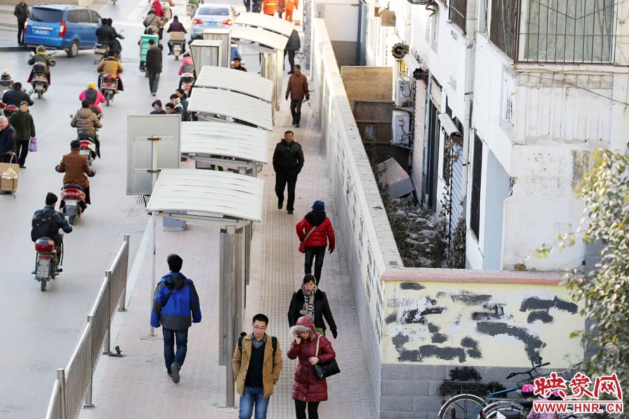 墻內(nèi)扔著垃圾，墻面上涂滿了牛皮癬小廣告，異常顯眼。