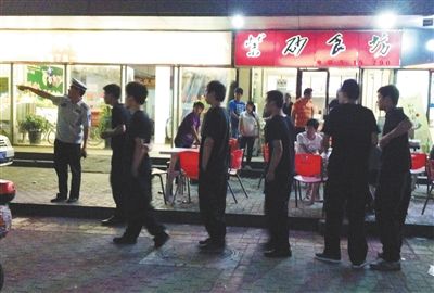 6月13日晚10點，朝陽區(qū)國美第一城附近，一名城管隊員帶領(lǐng)一隊協(xié)管例行巡查街邊大排檔。新京報記者 尹亞飛 攝