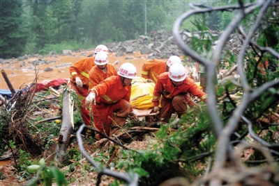 昨日，消防隊員在四川省都江堰市中興鎮(zhèn)三溪村滑坡現(xiàn)場運送遇難者遺體。新華社記者 薛玉斌 攝