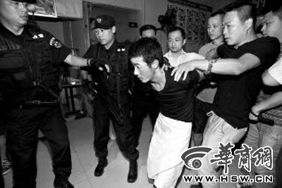犯罪嫌疑人韓牙某圍著圍裙在廚房內(nèi)拉面，被民警抓獲 本報(bào)記者 鄧小衛(wèi) 攝