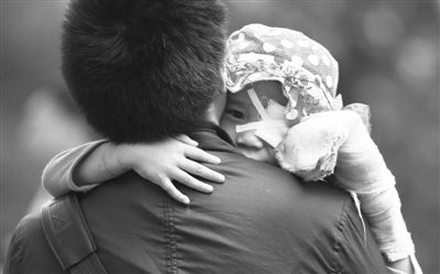 昨日，北京同仁醫(yī)院，被砍傷的彤彤趴在舅舅的肩上。他們剛剛掛完號，正準(zhǔn)備回旅館。新京報記者 尹亞飛 攝