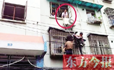 施救現(xiàn)場，劉鵬（圈內(nèi)）先用繩子捆住老太確保安全 勞動報記者 郭娜 供圖