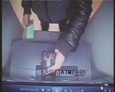 男子將可樂倒進(jìn)取款機。