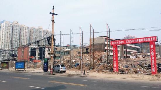 015年5月31日，在社區(qū)干部的帶頭拆遷下，親賢社區(qū)的“城中村改造”拉開帷幕。由于前期“清產(chǎn)核資”及補償標準等因素，拆遷改造工作推進并不順利。圖為位于體育西路東側(cè)集體所有的商鋪率先被拆遷完畢，用于遮擋的圍擋正在施工中。（拍攝：2015年9月16日）