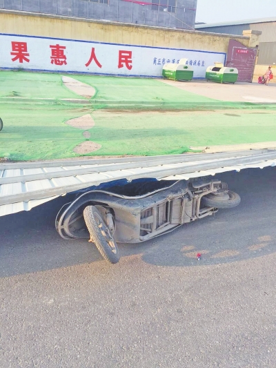 事發(fā)現(xiàn)場，男子的電動(dòng)車還在鐵皮墻下壓著。