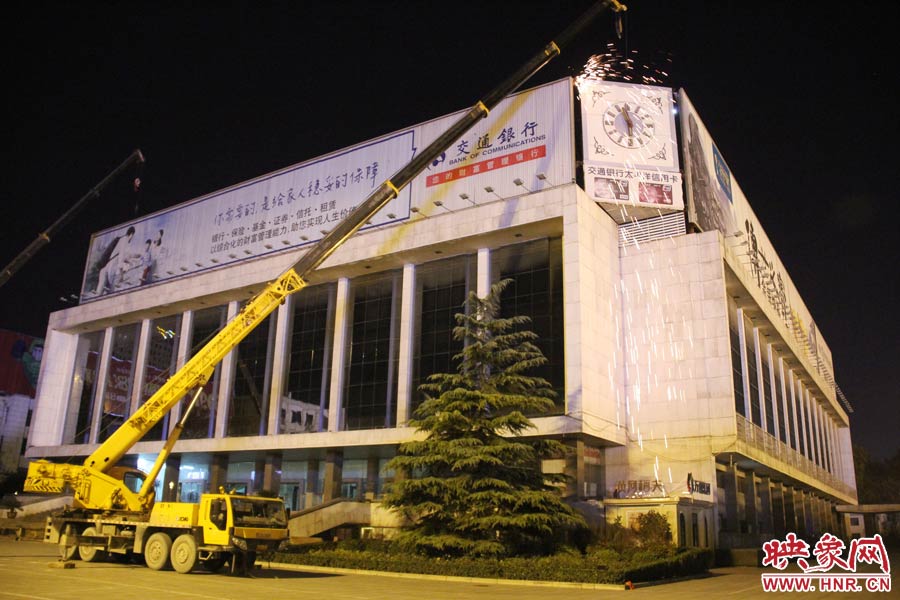 21點50分，切割機開始對中間最小的一塊牌進行切割。頂著“呼呼”的寒風，巨大廣告牌上火花四濺。