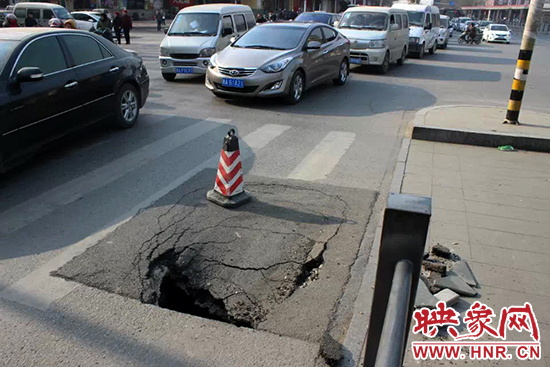 南陽(yáng)路農(nóng)業(yè)路出現(xiàn)深坑,近看是因?yàn)闉r青充當(dāng)窨井蓋所致 南陽(yáng)路農(nóng)業(yè)路出現(xiàn)深坑,近看是因?yàn)闉r青充當(dāng)窨井蓋所致