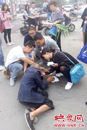 一些愛心市民在撥打了110和120后，上前給老人擦臉上的血跡。